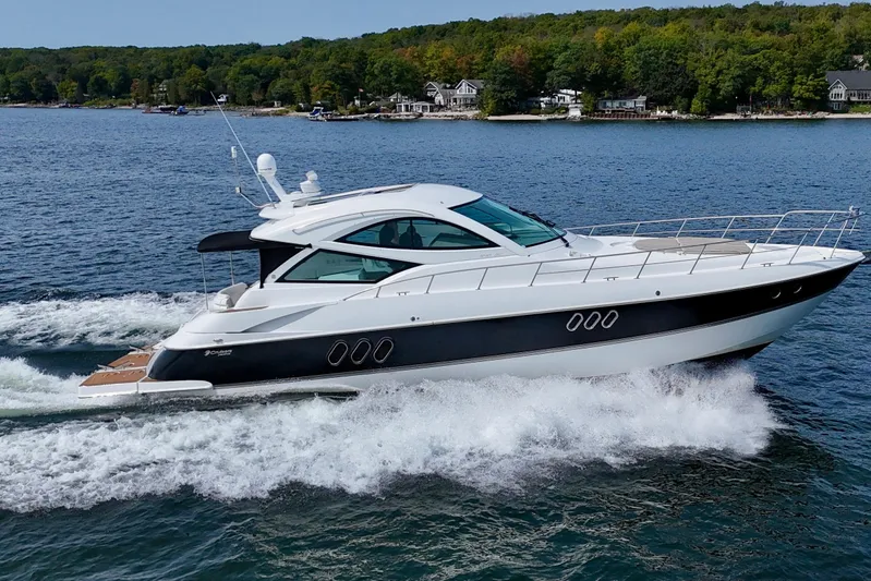  Yacht Photos Pics 2012 Cruisers Yachts 540 Sports Coupe cruising on a scenic lake.