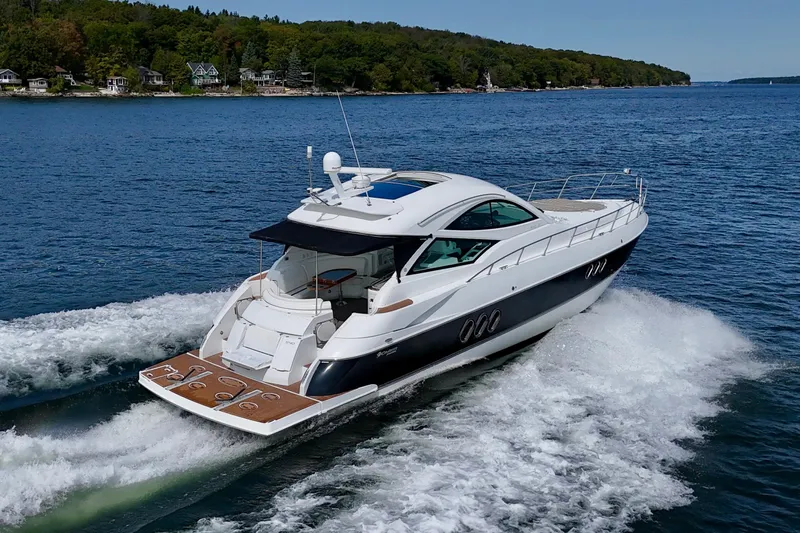  Yacht Photos Pics 2012 Cruisers Yachts 540 Sports Coupe cruising on a scenic lake.