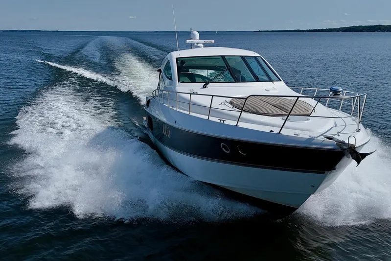  Yacht Photos Pics 2012 Cruisers Yachts 540 Sports Coupe speeding on open water.