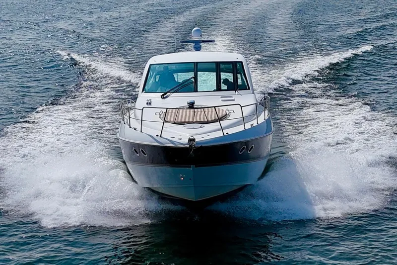  Yacht Photos Pics 2012 Cruisers Yachts 540 Sports Coupe cruising on open water.