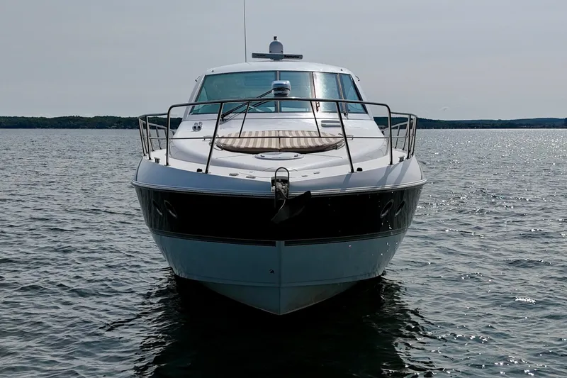  Yacht Photos Pics 2012 Cruisers Yachts 540 Sports Coupe on calm water, front view.