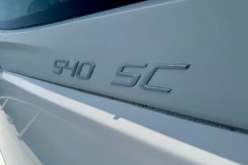  Yacht Photos Pics 2012 Cruisers Yachts 540 Sports Coupe emblem on white hull.