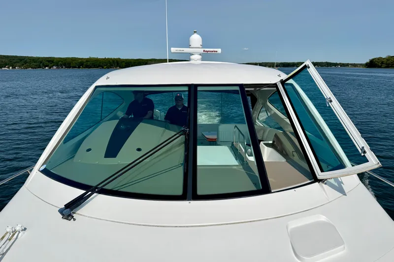  Yacht Photos Pics 2012 Cruisers Yachts 540 Sports Coupe on water, front view with open window.