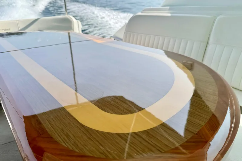  Yacht Photos Pics Luxurious wooden table on 2012 Cruisers Yachts 540 Sports Coupe, with ocean view.