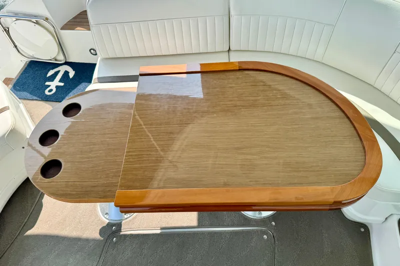  Yacht Photos Pics Luxurious interior of 2012 Cruisers Yachts 540 Sports Coupe with elegant wooden table.