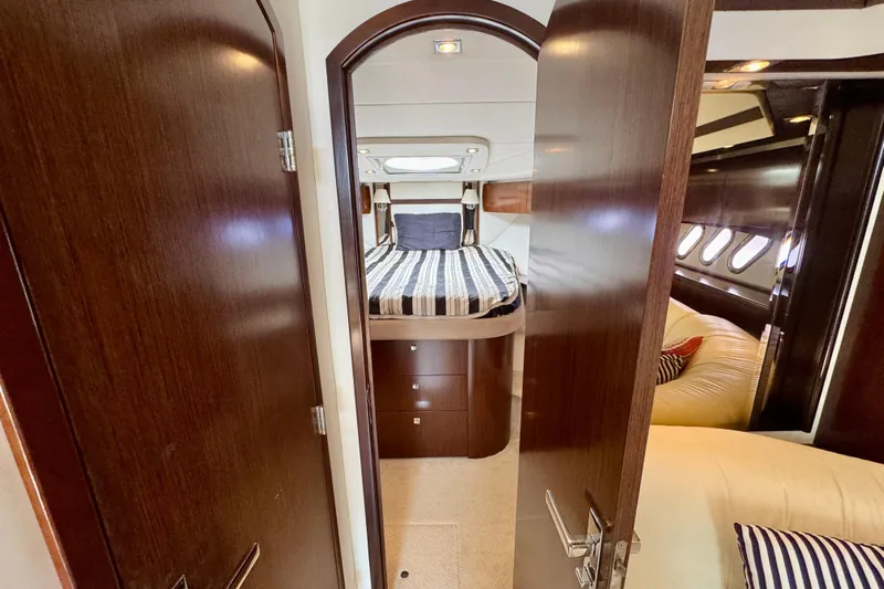  Yacht Photos Pics Luxurious interior of 2012 Cruisers Yachts 540 Sports Coupe with cozy bedroom and elegant wood finish.