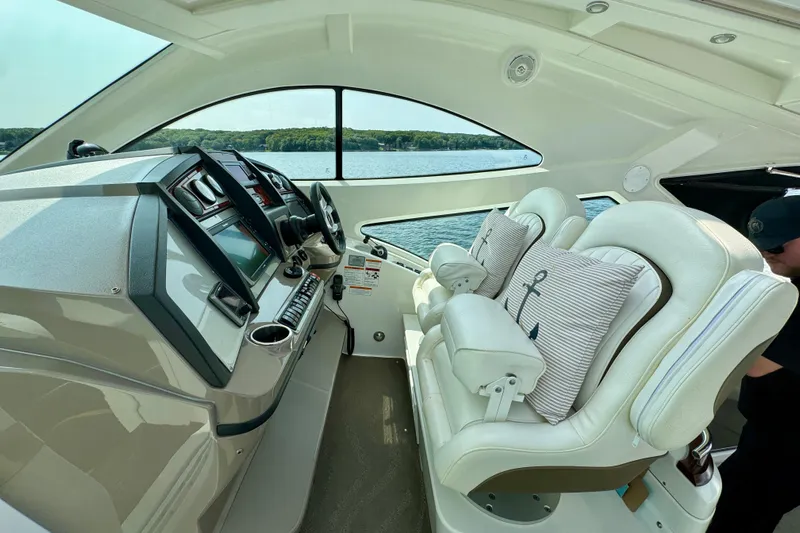  Yacht Photos Pics 2012 Cruisers Yachts 540 Sports Coupe helm with plush seating and modern controls.