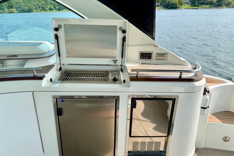  Yacht Photos Pics Outdoor kitchen on 2012 Cruisers Yachts 540 Sports Coupe, featuring grill and storage.