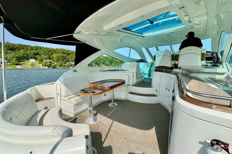  Yacht Photos Pics Luxurious 2012 Cruisers Yachts 540 Sports Coupe interior with elegant seating and scenic water view.