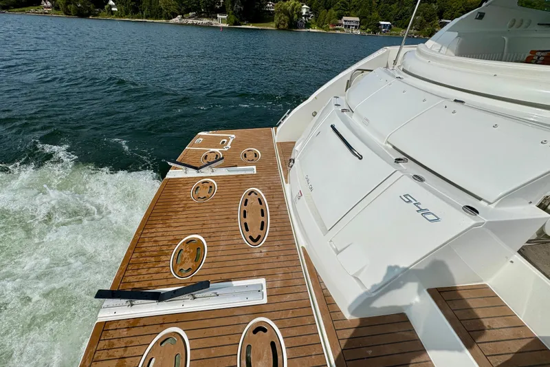  Yacht Photos Pics 2012 Cruisers Yachts 540 Sports Coupe on water, featuring teak deck and sleek design.