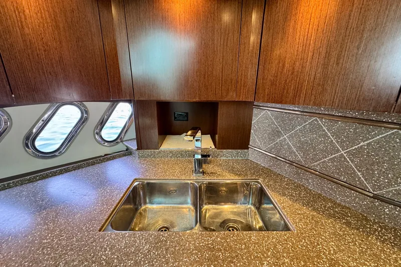  Yacht Photos Pics Luxurious kitchen interior of 2012 Cruisers Yachts 540 Sports Coupe with modern sink and cabinetry.