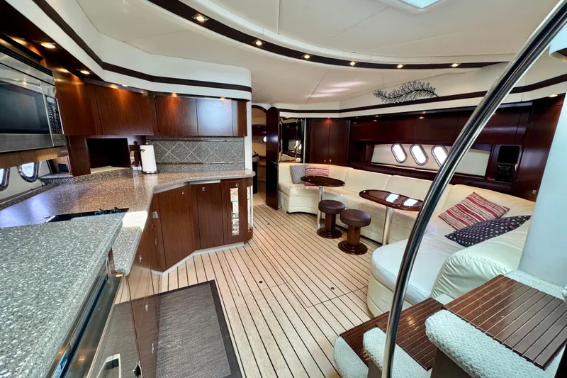  Yacht Photos Pics Luxurious interior of 2012 Cruisers Yachts 540 Sports Coupe with modern kitchen and seating area.