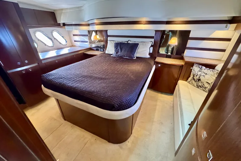  Yacht Photos Pics Luxurious bedroom interior of 2012 Cruisers Yachts 540 Sports Coupe with elegant furnishings.