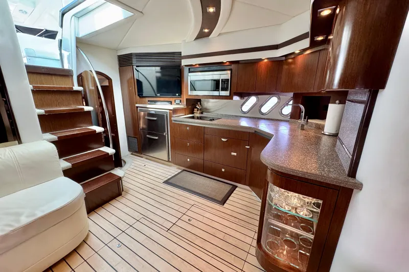  Yacht Photos Pics Luxurious interior of 2012 Cruisers Yachts 540 Sports Coupe with modern kitchen amenities.