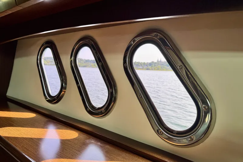  Yacht Photos Pics Porthole windows on 2012 Cruisers Yachts 540 Sports Coupe, overlooking serene water view.