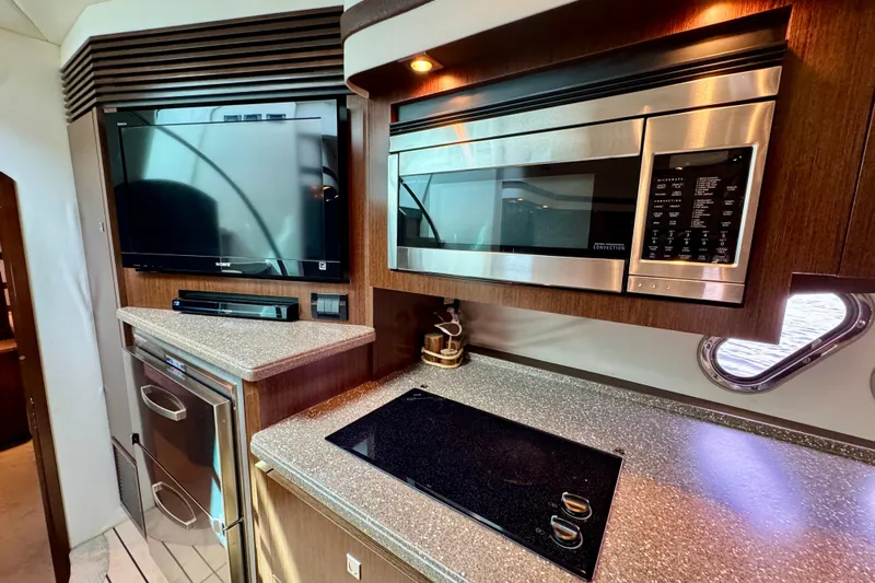  Yacht Photos Pics Luxurious 2012 Cruisers Yachts 540 Sports Coupe kitchen with modern appliances and sleek design.