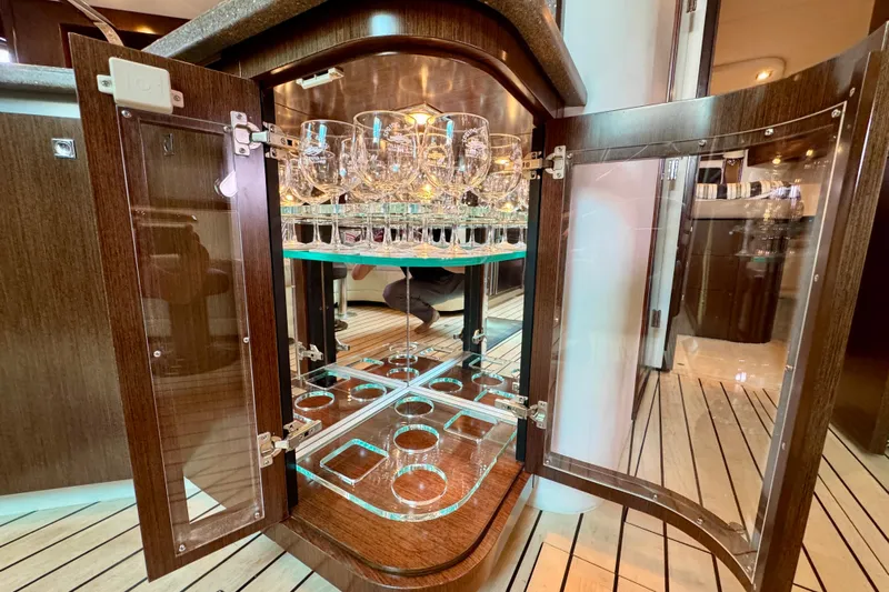  Yacht Photos Pics Luxurious glass cabinet on 2012 Cruisers Yachts 540 Sports Coupe, featuring elegant glassware display.