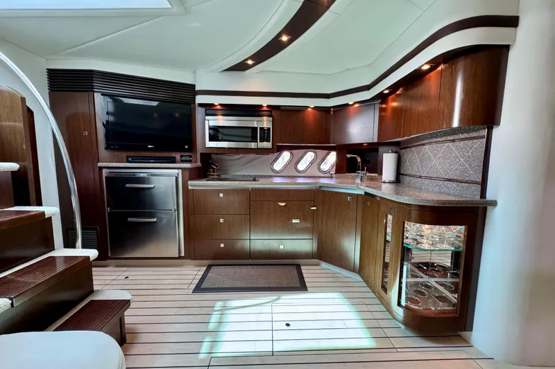  Yacht Photos Pics Luxurious 2012 Cruisers Yachts 540 Sports Coupe interior with modern kitchen amenities.