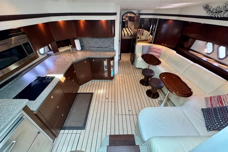 Yacht Photos Pics Luxurious interior of 2012 Cruisers Yachts 540 Sports Coupe with modern kitchen and seating area.