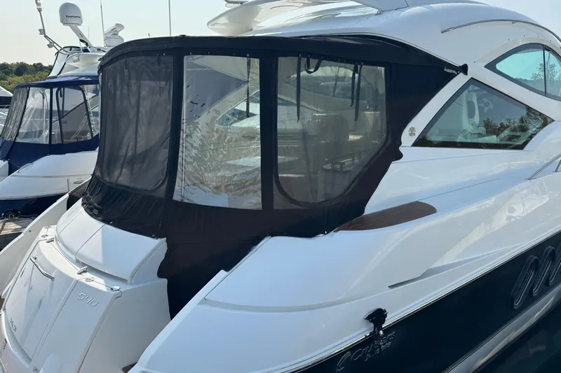  Yacht Photos Pics 2012 Cruisers Yachts 540 Sports Coupe docked with protective cover.