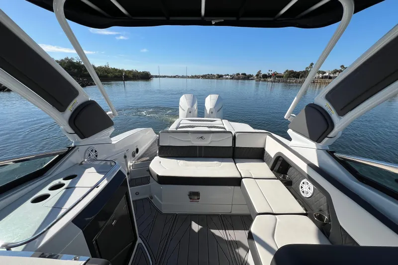  Yacht Photos Pics 2023 Monterey 305SS Super Sport boat interior with luxurious seating on a sunny day.