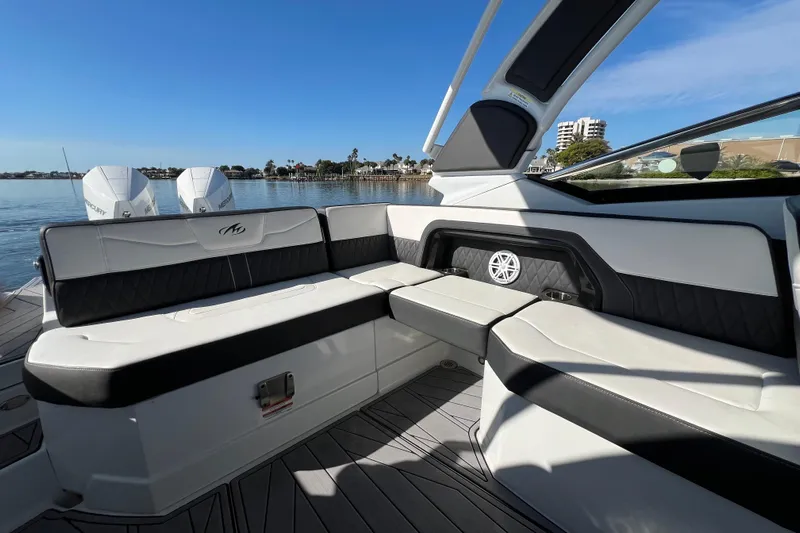  Yacht Photos Pics 2023 Monterey 305SS Super Sport boat interior with luxurious seating and scenic waterfront view.