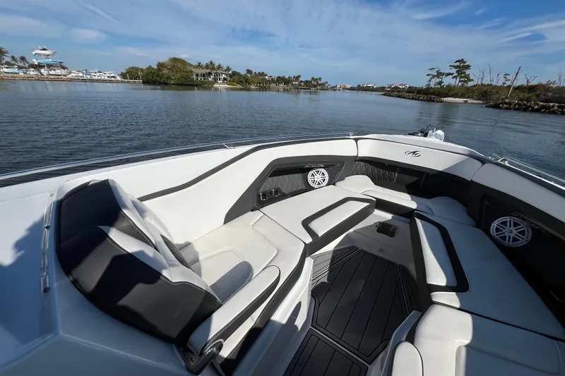  Yacht Photos Pics 2023 Monterey 305SS Super Sport boat interior with luxurious seating on a sunny day.
