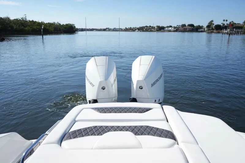 Yacht Photos Pics 2023 Monterey 305SS Super Sport boat with dual Mercury engines on a calm lake.