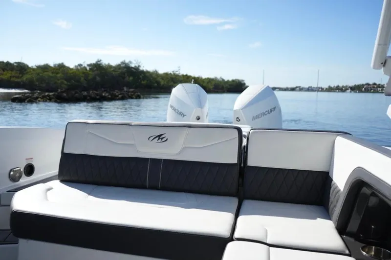  Yacht Photos Pics 2023 Monterey 305SS Super Sport boat interior with dual Mercury engines on a calm lake.