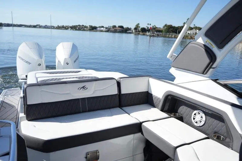  Yacht Photos Pics 2023 Monterey 305SS Super Sport boat interior with dual Mercury engines on a calm lake.