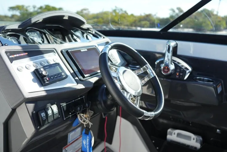  Yacht Photos Pics 2023 Monterey 305SS Super Sport boat dashboard with steering wheel and control panel.