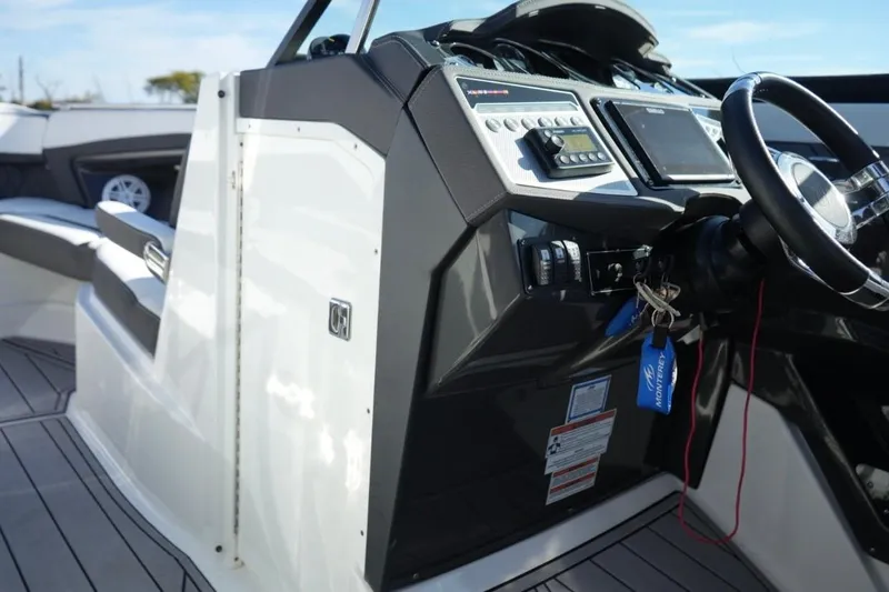  Yacht Photos Pics 2023 Monterey 305SS Super Sport boat dashboard with steering wheel and controls.