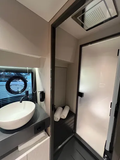  Yacht Photos Pics Modern bathroom in 2025 FIM 440 Regina, featuring sleek sink and shower area.