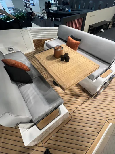  Yacht Photos Pics Luxury seating area on 2025 FIM 440 Regina yacht with wooden table and cushions.