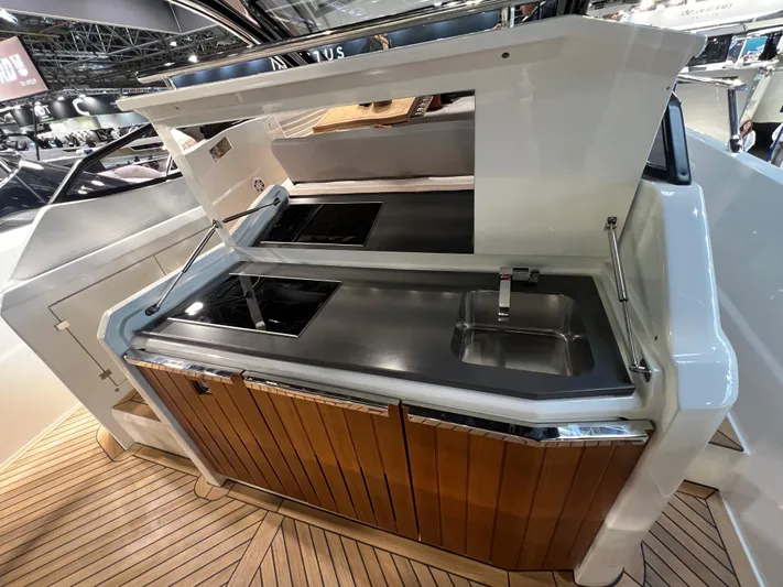  Yacht Photos Pics Modern outdoor kitchen on 2025 FIM 440 Regina yacht with sleek design and wooden cabinetry.