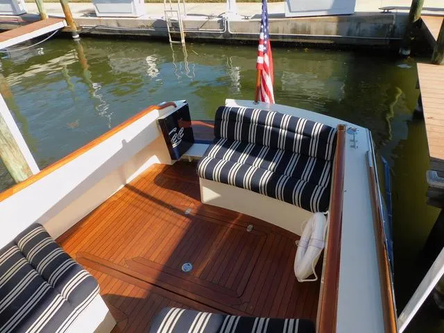  Yacht Photos Pics 2013 Hinckley T34 boat interior with striped seating and wooden deck.