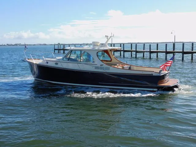 Yacht Photos Pics 2013 Hinckley T34 yacht cruising on a sunny day near a pier.
