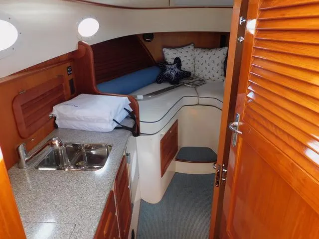  Yacht Photos Pics Interior of 2013 Hinckley T34 yacht with cozy cabin and kitchenette.