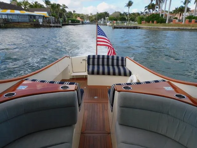  Yacht Photos Pics 2013 Hinckley T34 boat with American flag, cruising on a scenic waterway.
