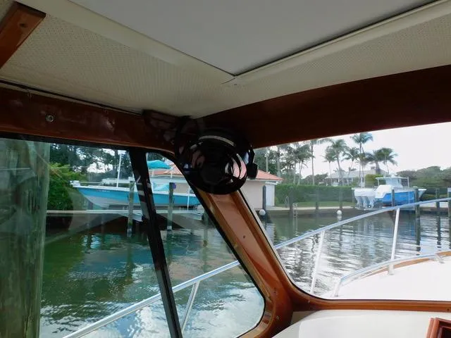  Yacht Photos Pics Interior view of 2013 Hinckley T34 boat docked near waterfront homes.