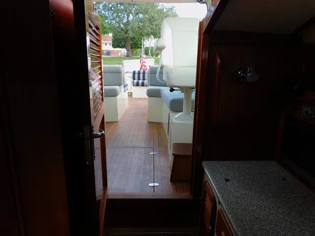  Yacht Photos Pics Interior view of 2013 Hinckley T34 yacht, featuring wooden flooring and cushioned seating.