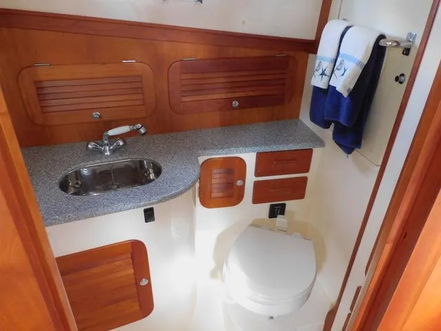  Yacht Photos Pics Hinckley T34 2013 yacht bathroom with wood cabinetry and modern fixtures.