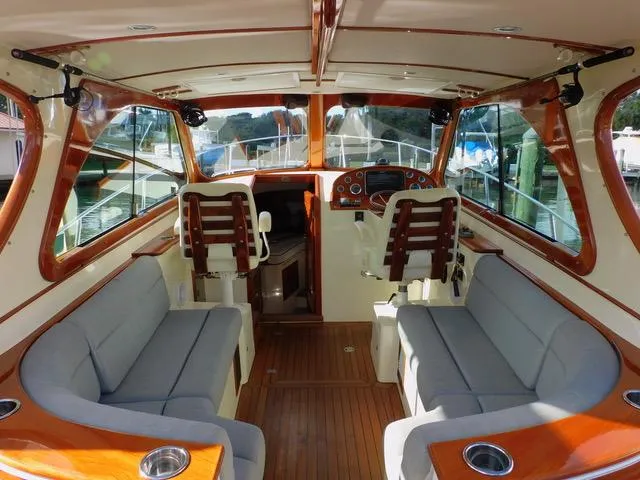  Yacht Photos Pics Interior of 2013 Hinckley T34 boat with wooden accents and gray seating.