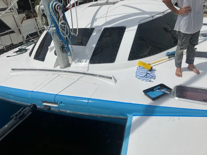 Freedom Yacht Photos Pics Lagoon 42 catamaran, 1993 model, docked with cleaning supplies on deck.