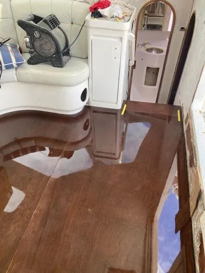 Freedom Yacht Photos Pics Interior of 1993 Lagoon 42 yacht with polished wooden floor and seating area.