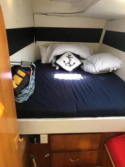 Freedom Yacht Photos Pics Cozy cabin interior of 1993 Lagoon 42 with nautical-themed bedding and storage.