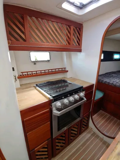 Freedom Yacht Photos Pics Interior of 1993 Lagoon 42 yacht kitchen with stove and wooden cabinetry.