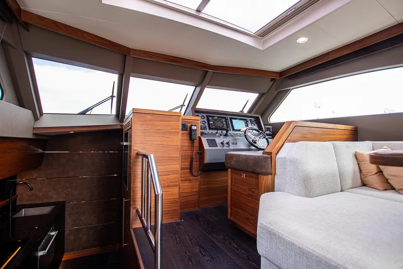  Yacht Photos Pics Luxurious interior of 2021 Van der Heijden Exclusive de Luxe 1600 yacht, featuring modern helm and seating.