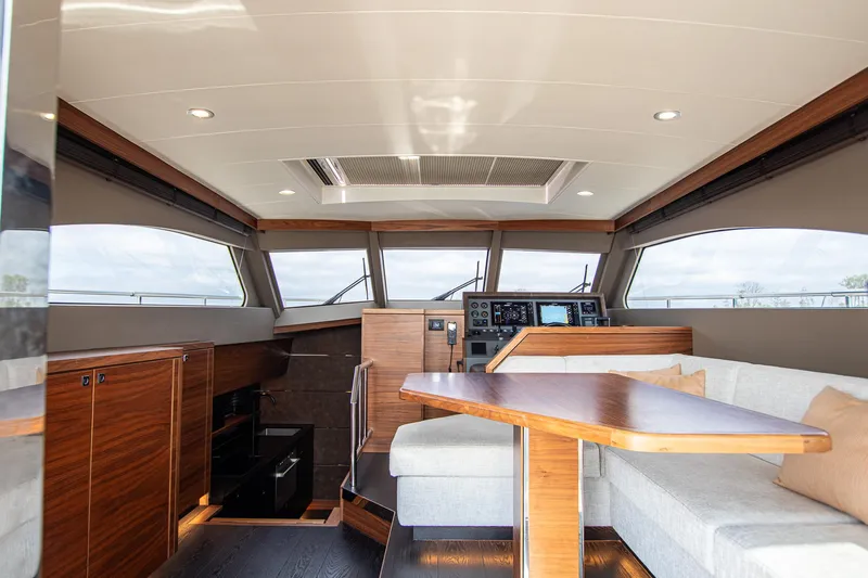  Yacht Photos Pics Luxurious interior of 2021 Van der Heijden Exclusive de Luxe 1600 yacht with modern helm and seating.