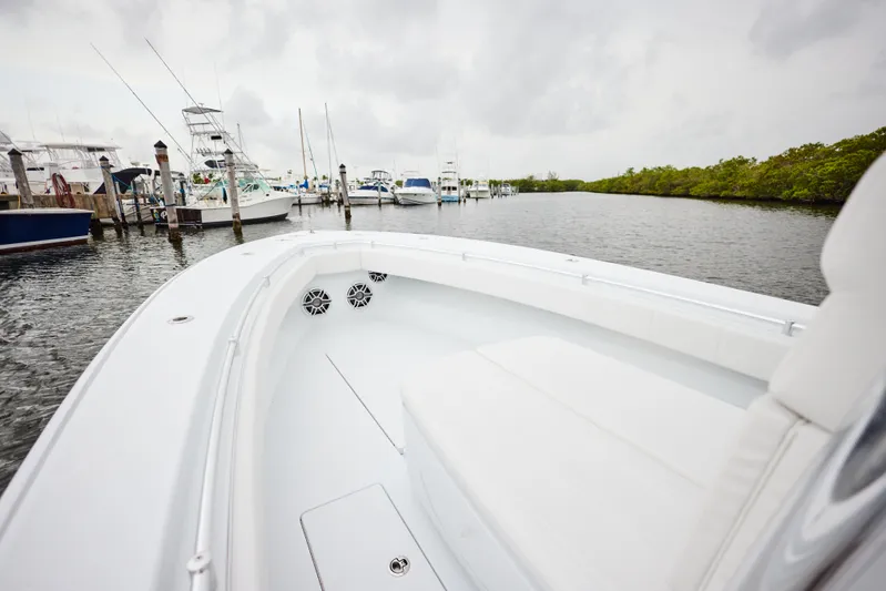  Yacht Photos Pics 2026 Contender 32 ST boat docked in a marina, featuring sleek white design.